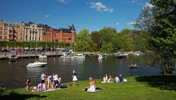 People sitting enjoying the view near a river in östermalm, Stockholm | foreignxchange